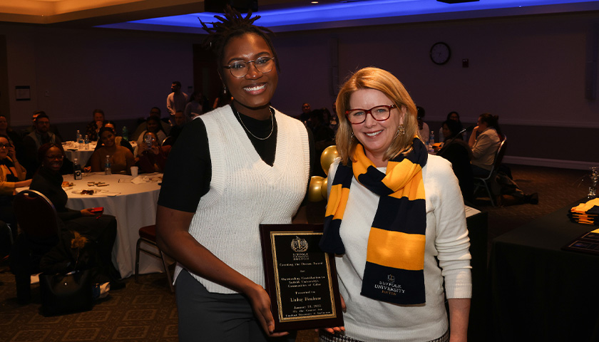 Undergrad Lindsay Dieudonne accepts her Creating the Dream Award from Laura Ferrari, vice president for student affairs