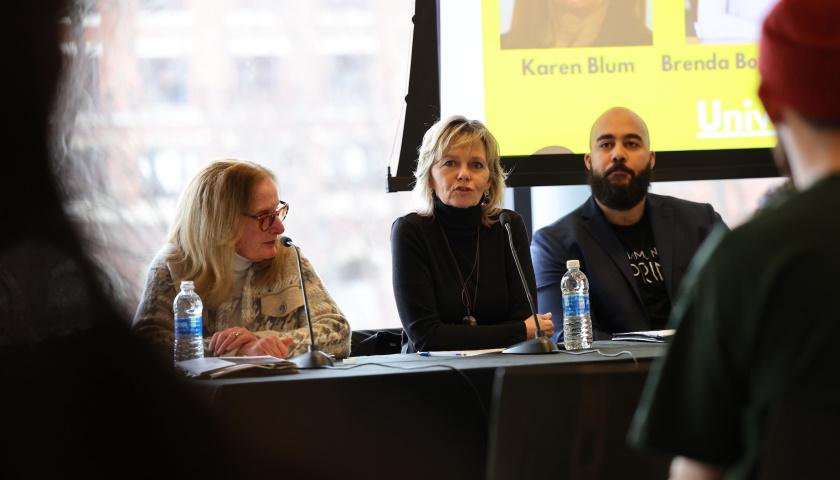 Panel shows Professors Karen Blum, Brenda Bond-Fortier, and Lucius Couloute; Bond-Fortier is speaking