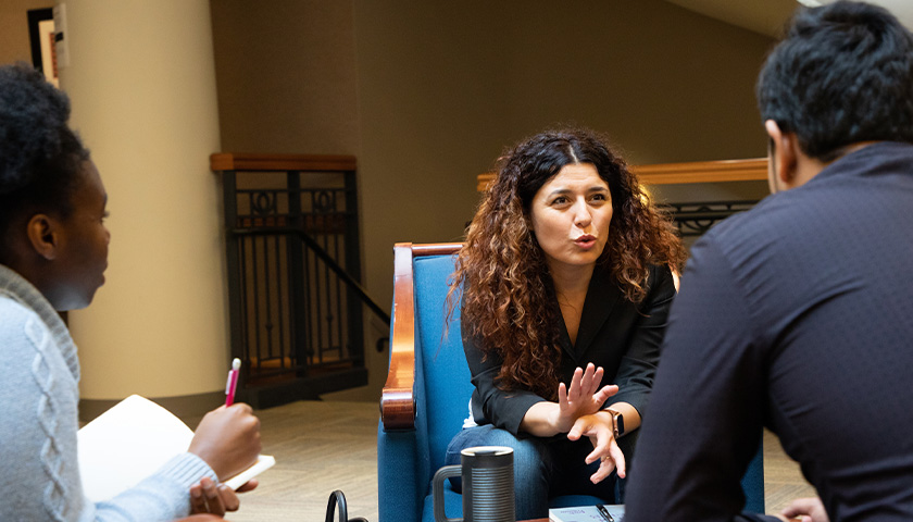 Image of Professor Pelin Bicen chatting with students