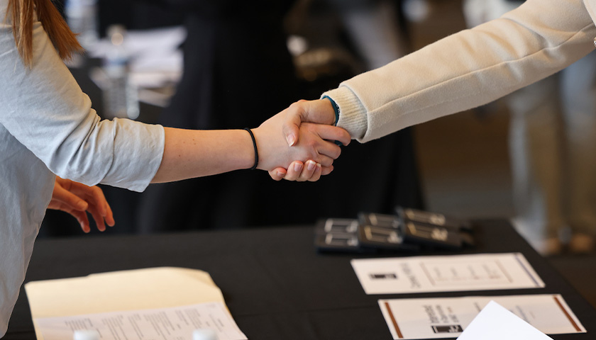 Two people shake hands at the 2023 career fair