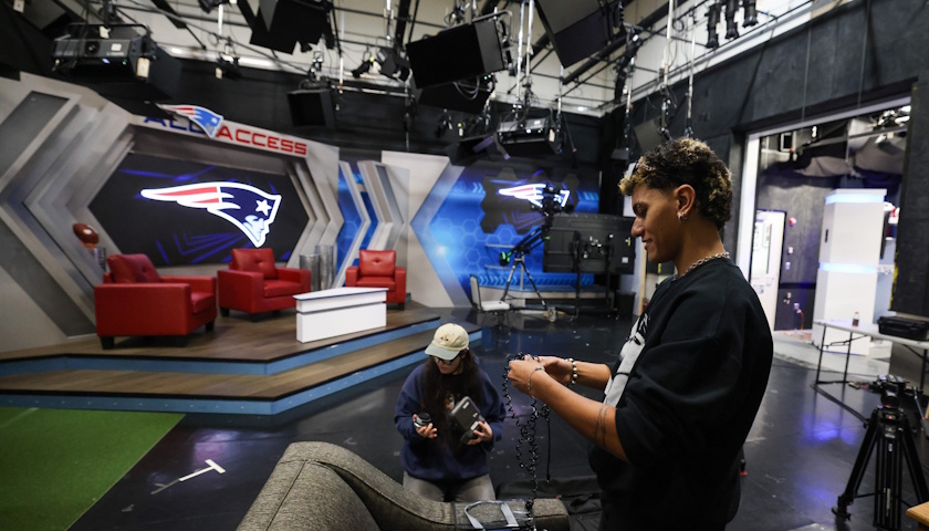 Students prepare filming gear in a Gillette Stadium studio