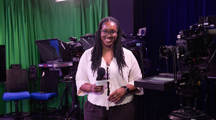 Areta Odiah stands in front of a camera in Studio 73
