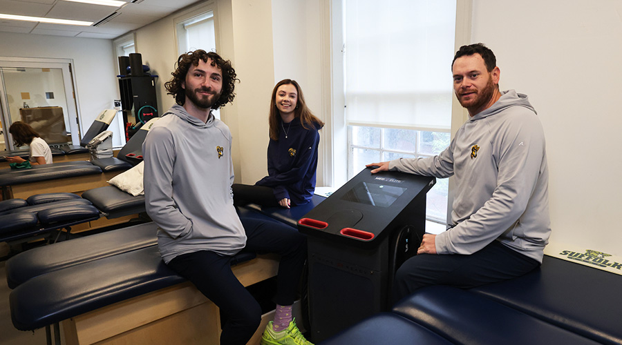 Two men and a woman who are trainers for Suffolk University athletes in the training facilities