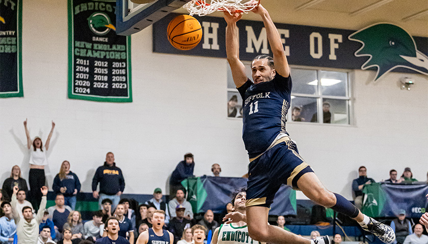 Keenan Robertson dunks a basketball while the crowd cheers behind him