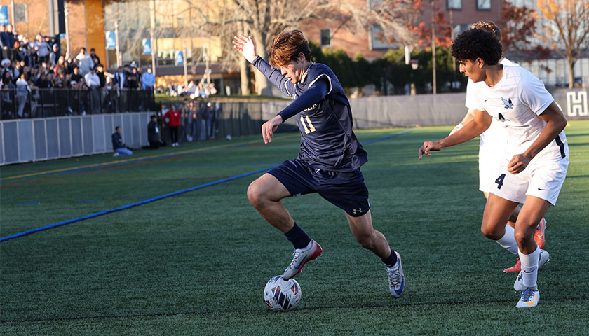 Mens soccer player Francisco Valck outruns an opponent at the CNE championship game
