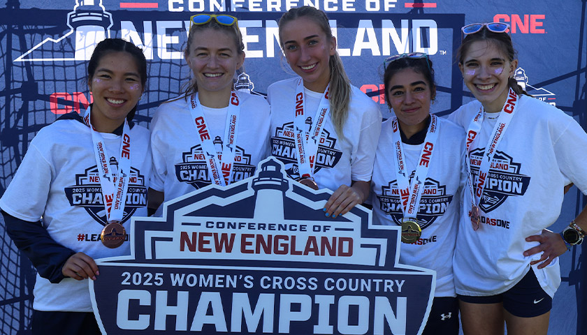 Suffolk’s top-five women cross country runners hold the CNE championship sign
