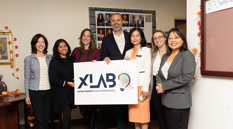 Students and administrators holding an X-Lab sign at the laboratory's launch