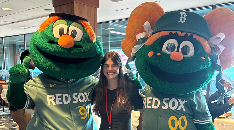 Anja Wight standing in between Red Sox mascots Wally and Tessie