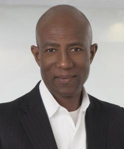 Headshot of Abim Kolawole in a white shirt and black blazer