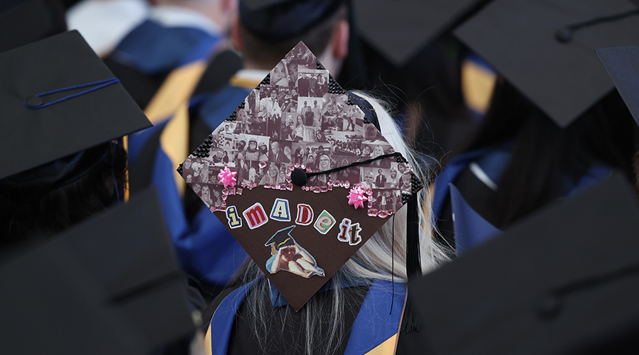 Decorated graduate mortar board with photos and the words "I Made it"