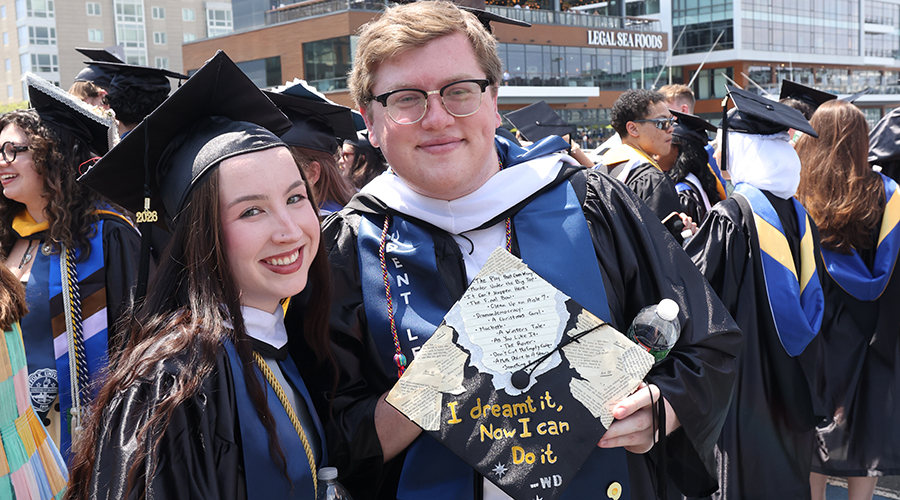 Two students in caps and gowns and colorful stoles waiting for the College of Arts & Sciences Commencement 2026 to begin