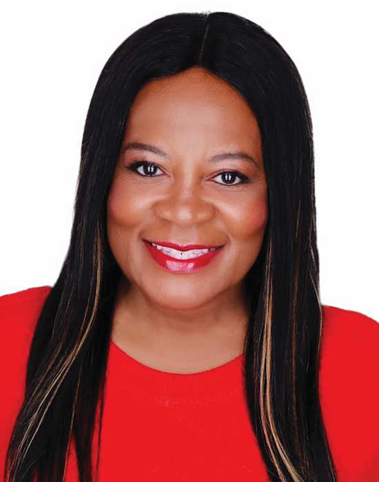 Headshot of Cheree McAlpine smiling wearing red on a white background