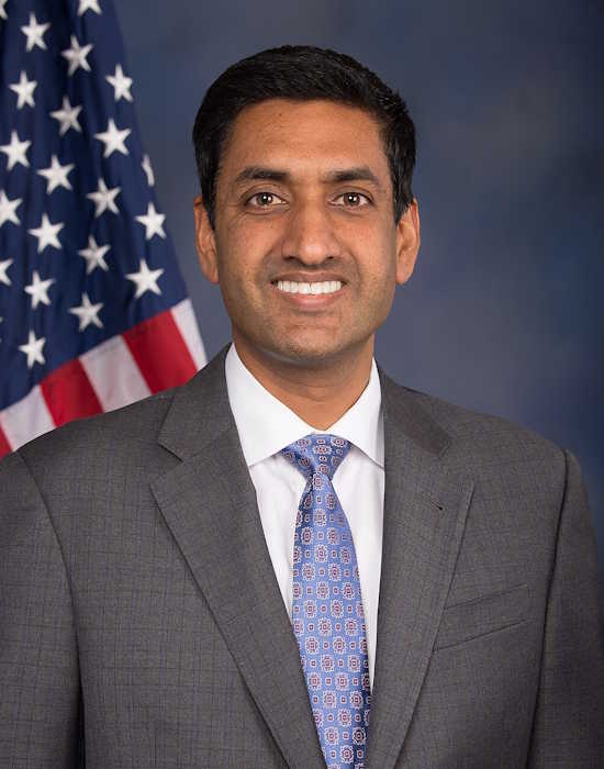 Portrait of Ro Khanna smiling in front of the American flag