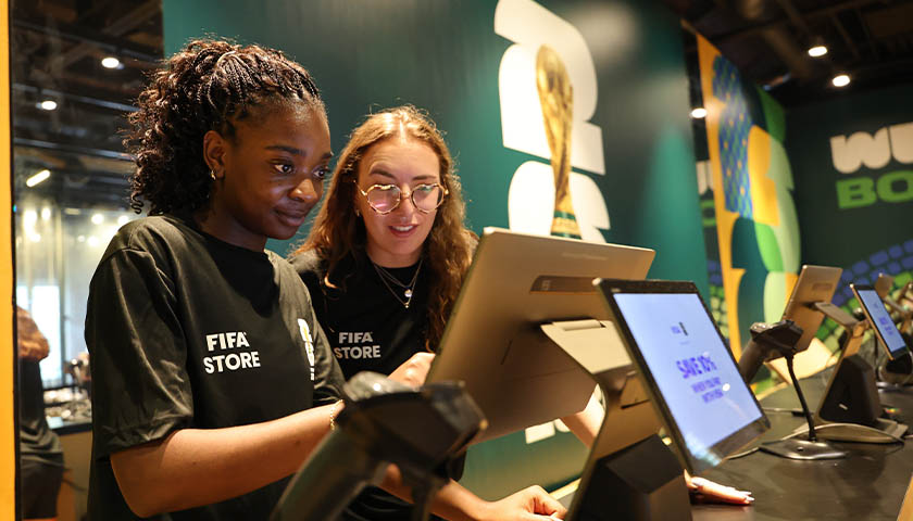 Suffolk student retail associates Imani Chanka and Audrey Fields ring up merchandise at the FIFA World Cup Boston store