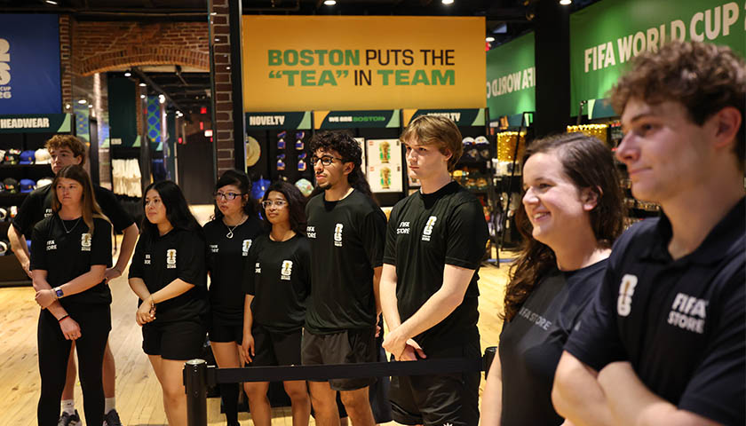Small group of Suffolk student retail associates and FIFA World Cup Boston store supervisor Colin Sheehan, BSBA ’25