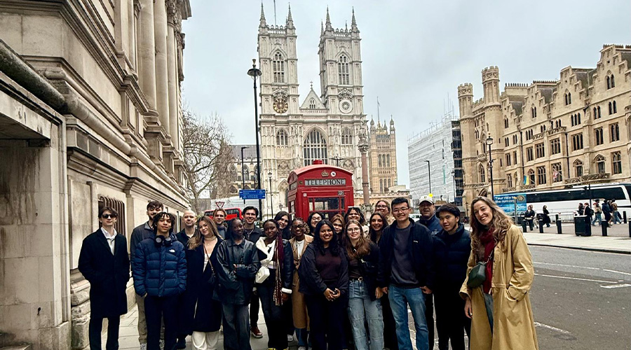 Suffolk students in London with Westminster Abbey and a traditional red phone box behind them
