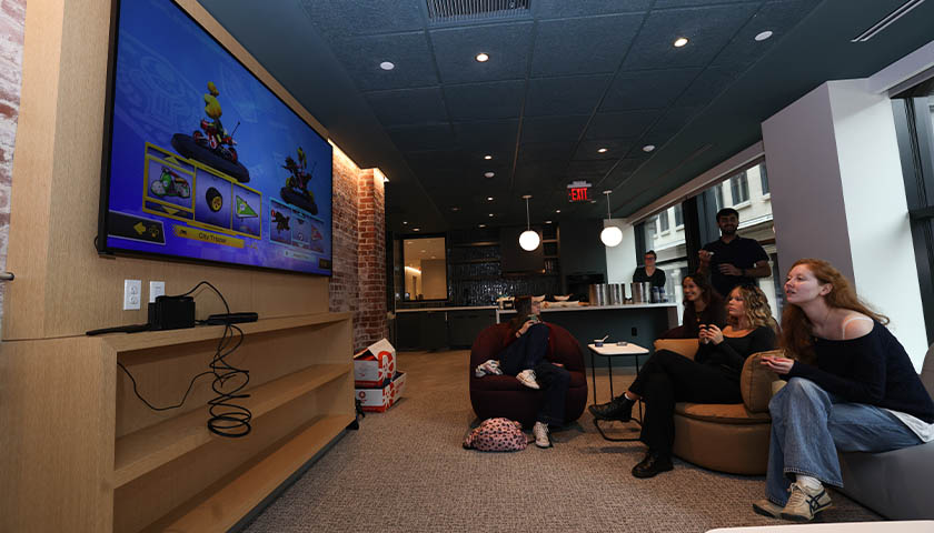 Students play video games on the lounge's large flatscreen video monitor
