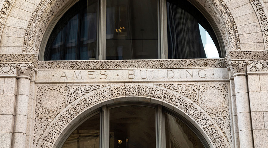 Closeup of Ames Building arched doorway with intricate carving in stonework