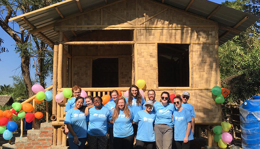 Students in front of bamboo house