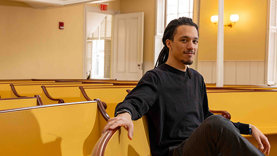 A historian sits in the pews of the African Meeting House in Boston, MA.