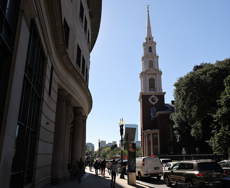 A side-view of Suffolk's Sargent Hall and the Park Street Church Tower