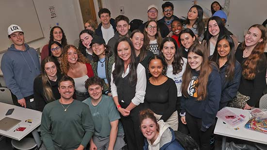 Suffolk students in a classroom, one looks confidently to camera
