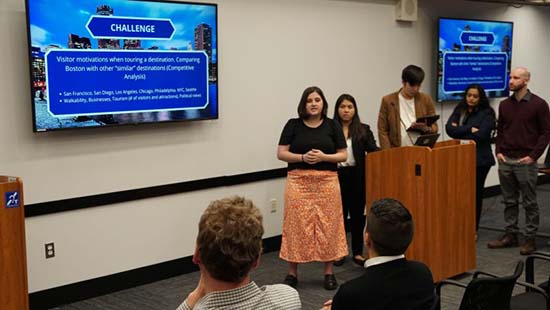 A panel of Suffolk students giving a presentation.