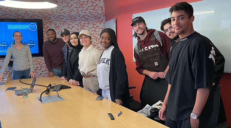 Students from the Center standing at a table and smiling at the camera