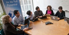 W3C COO Ralph Swick interview, people having a meeting and with pc on the table