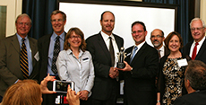 8 people taking a picture of them holding awards, GLIC Award