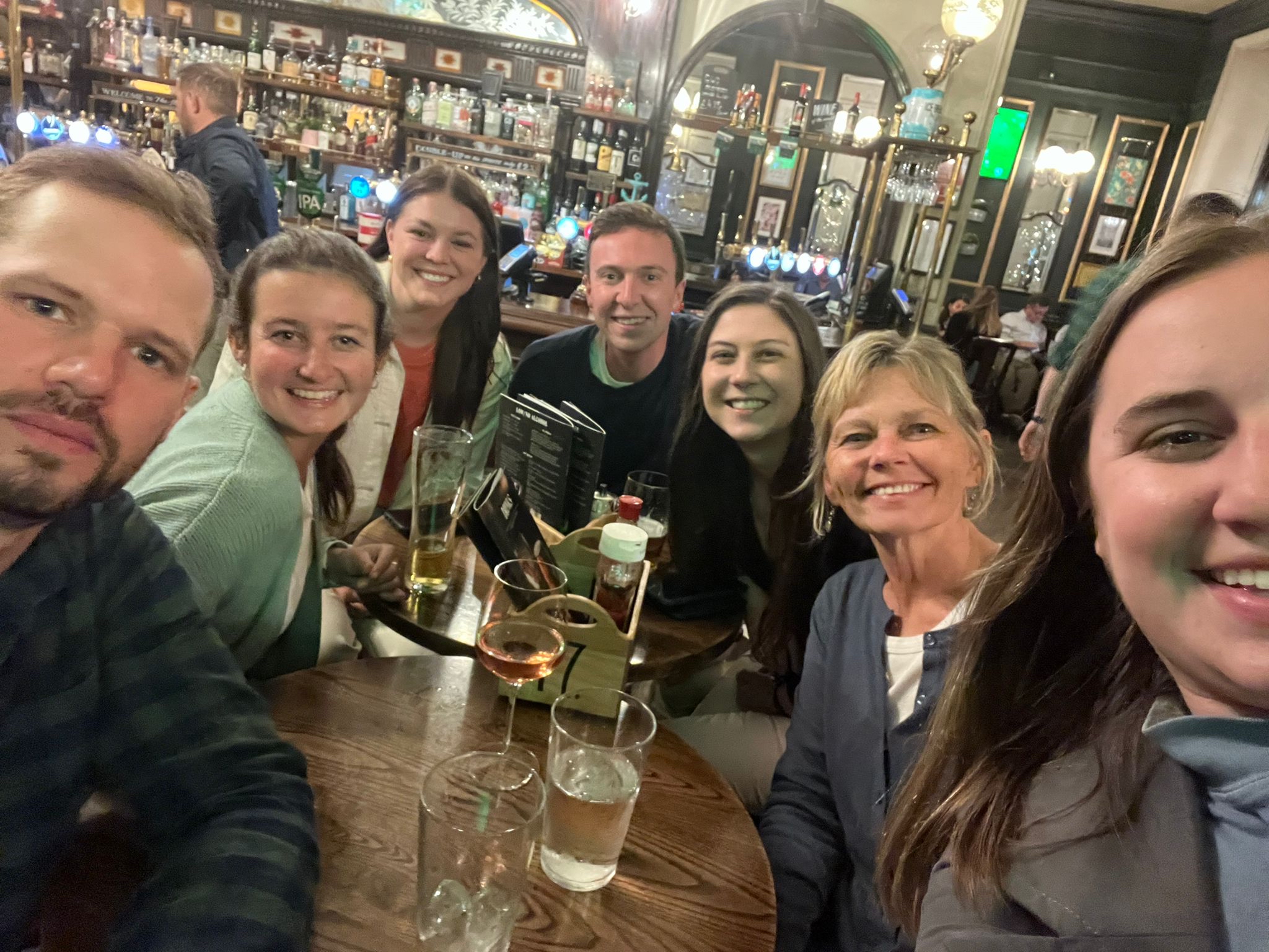Students and faculty enjoying the 2022 MHA Travel Seminar in a pub in England