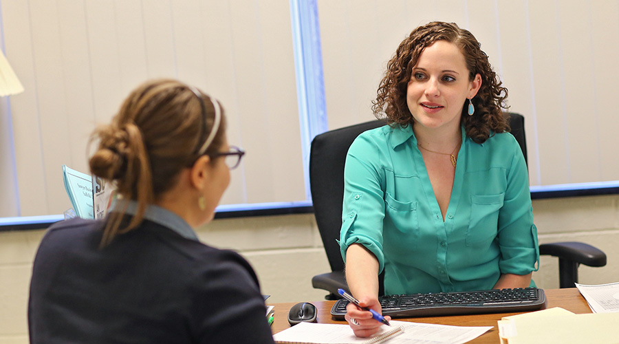 A Suffolk graduate student in an academic advising meeting.