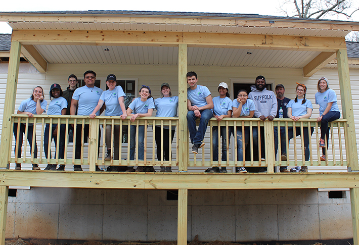 Some Suffolk students who participated in a University-sponsored Habitat for Humanity Alternative Spring Break trip pose for a group photo