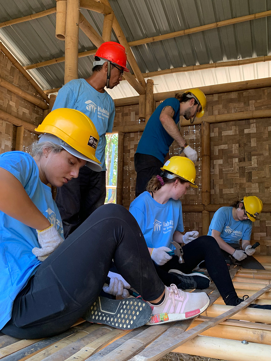 Suffolk University students working with a Burmese community to build a home in Bago, Myanmar with Habitat for Humanity International. 