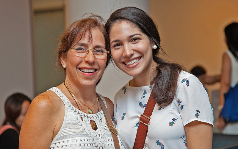 A student poses with her mother at a welcome reception for new international students.