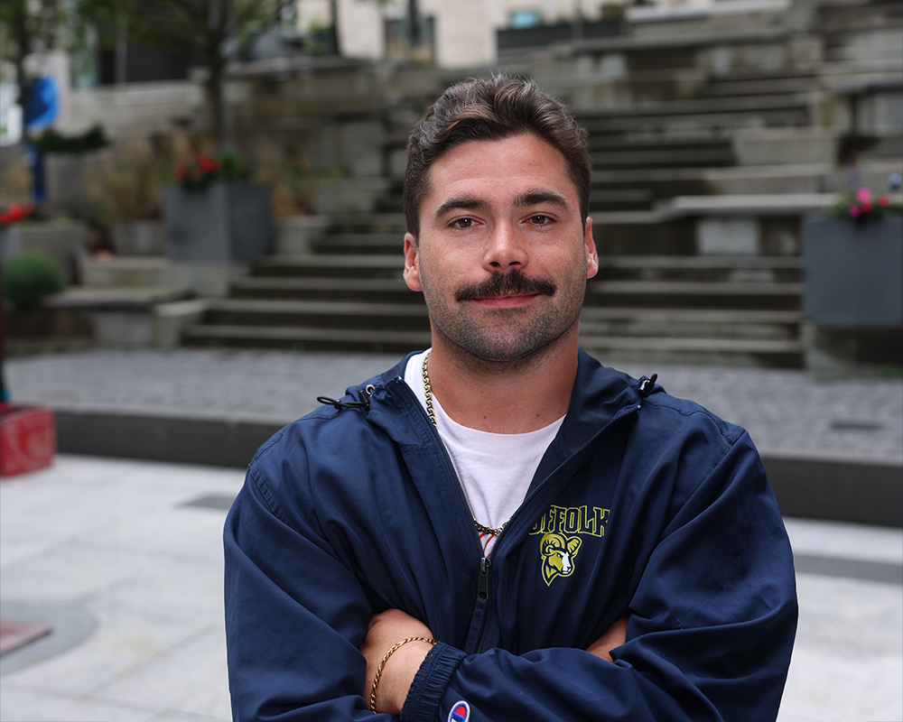 Photo of Ram Supporter standing in Roemer Plaza on campus at Suffolk University.