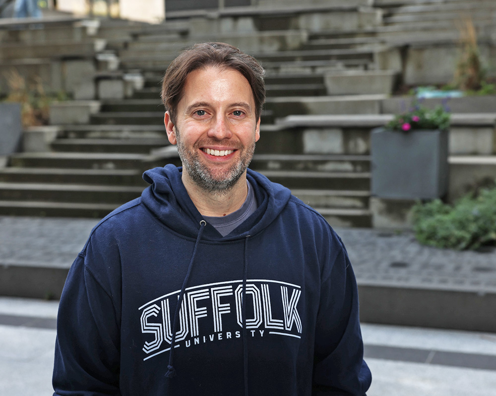 Photo of Ram Supporter standing in Roemer Plaza on campus at Suffolk University.