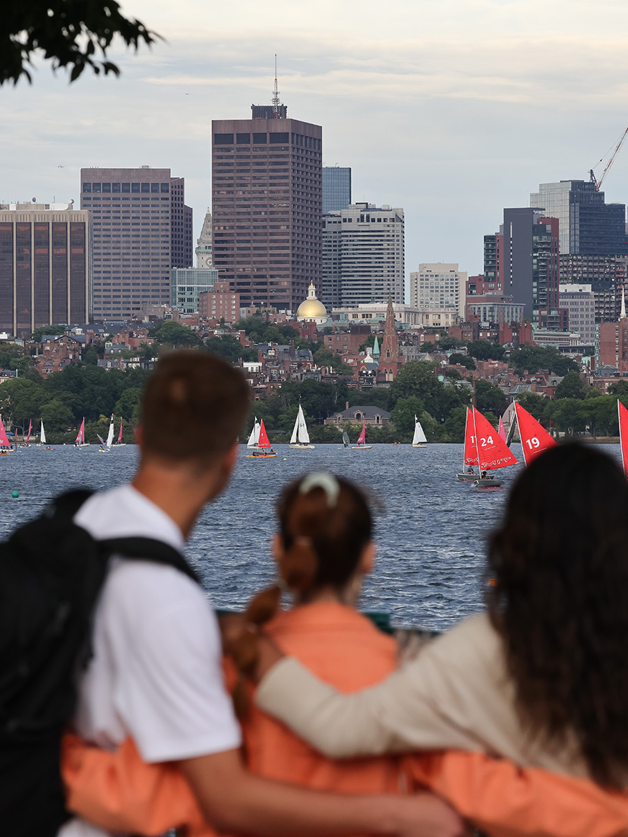 Suffolk students embrace as they look across the Charles River to Suffolk's campus.