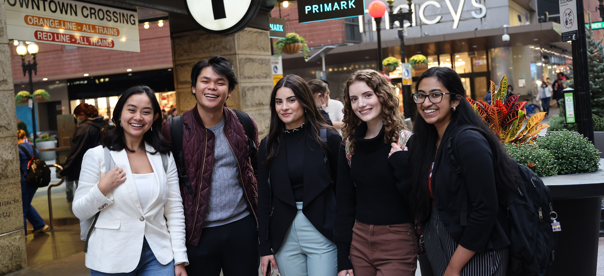 Suffolk students standing confidently in Downtown Crossing, Boston