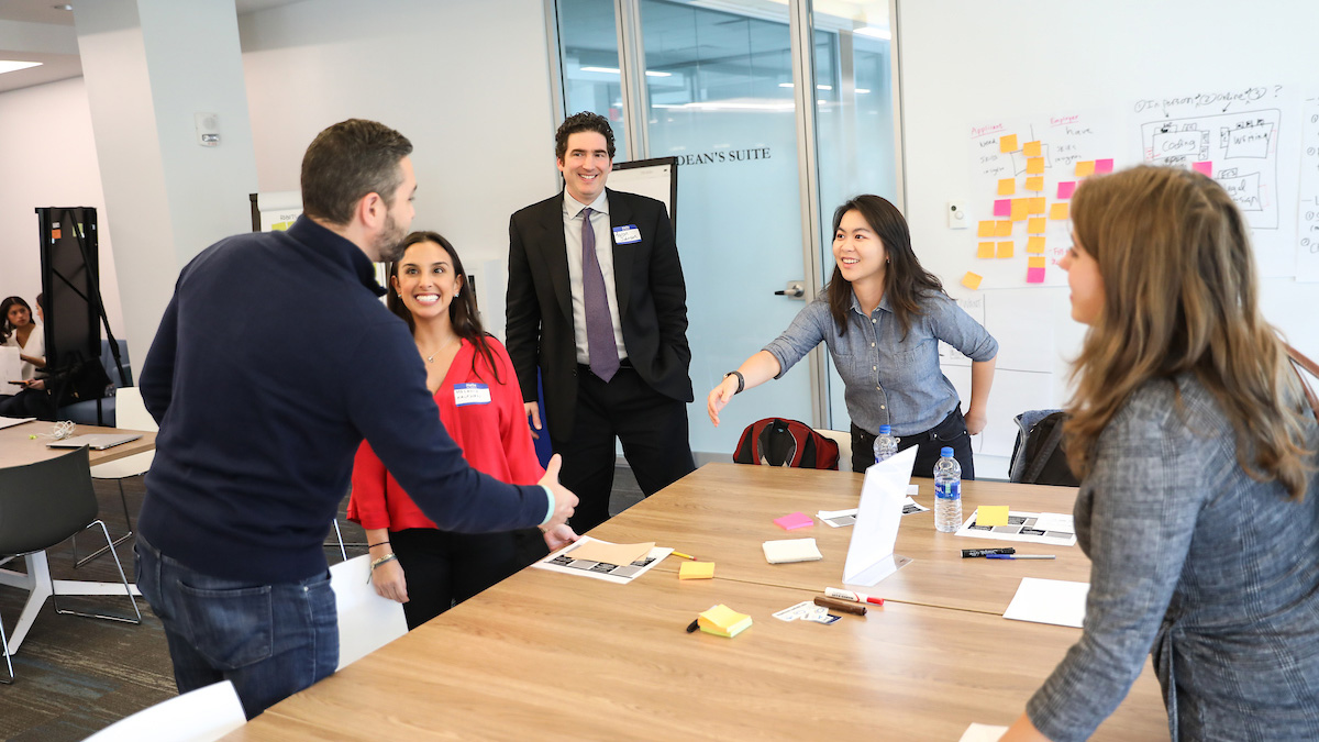 Suffolk students meet with a client for a class project.