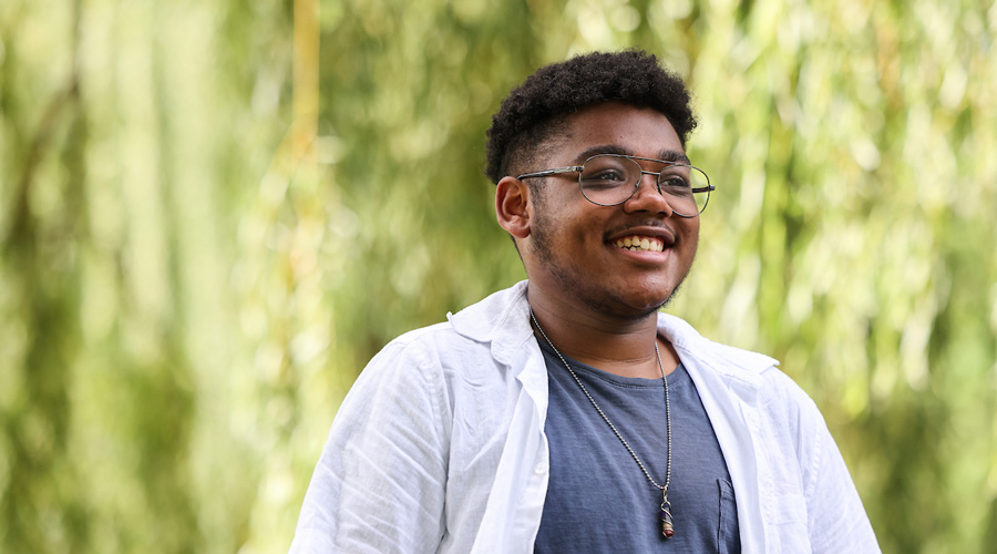 Suffolk student Vinny smiles for a portrait in the Boston Public Garden.
