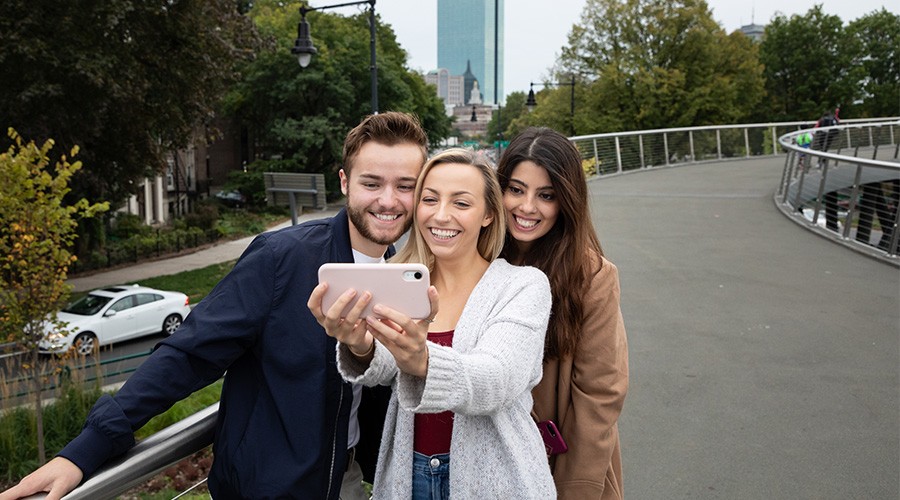 Suffolk students stop for a selfie while exploring downtown Boston.