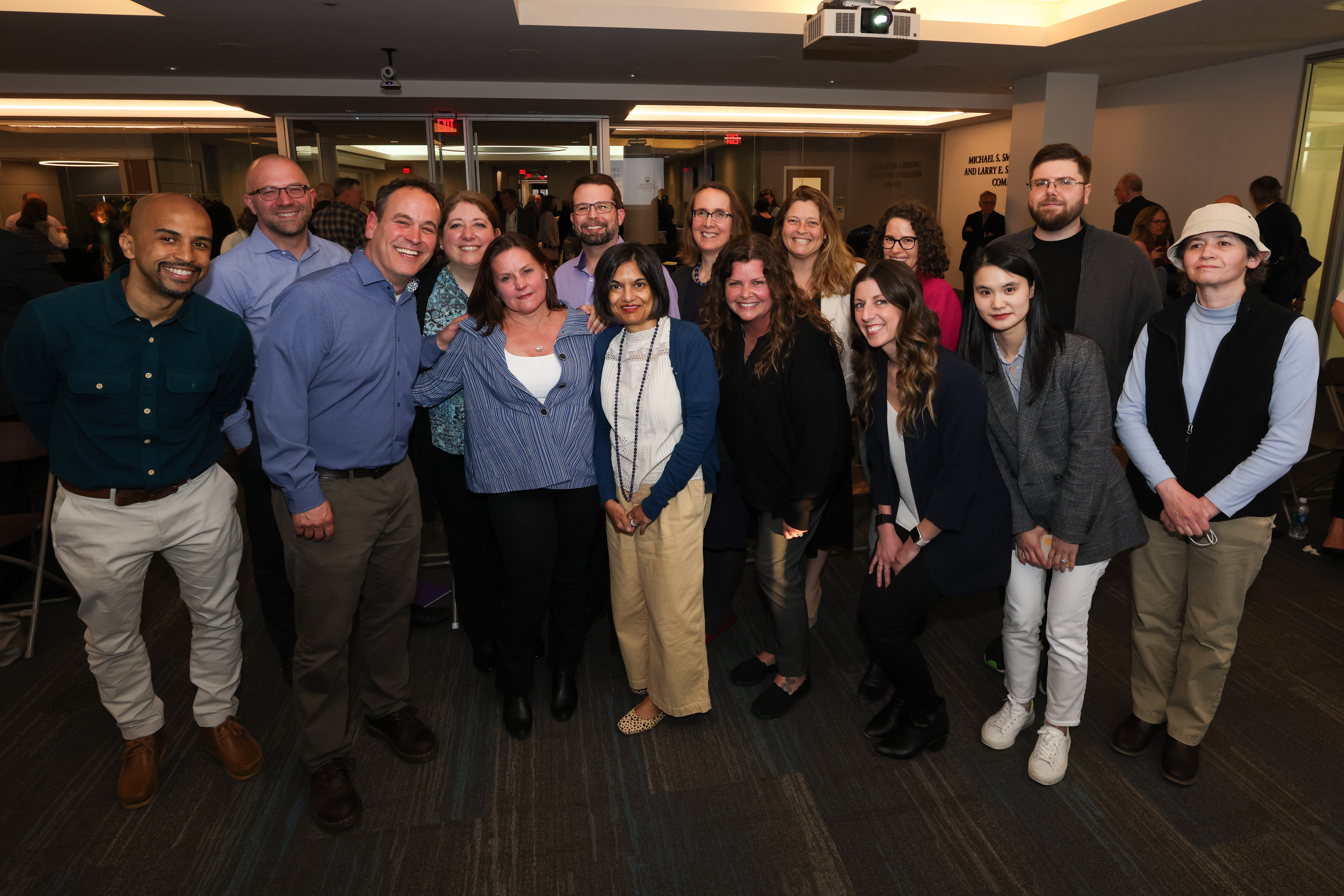 Faculty members of Suffolk University's College of Arts & Sciences pose together at a recognition event.