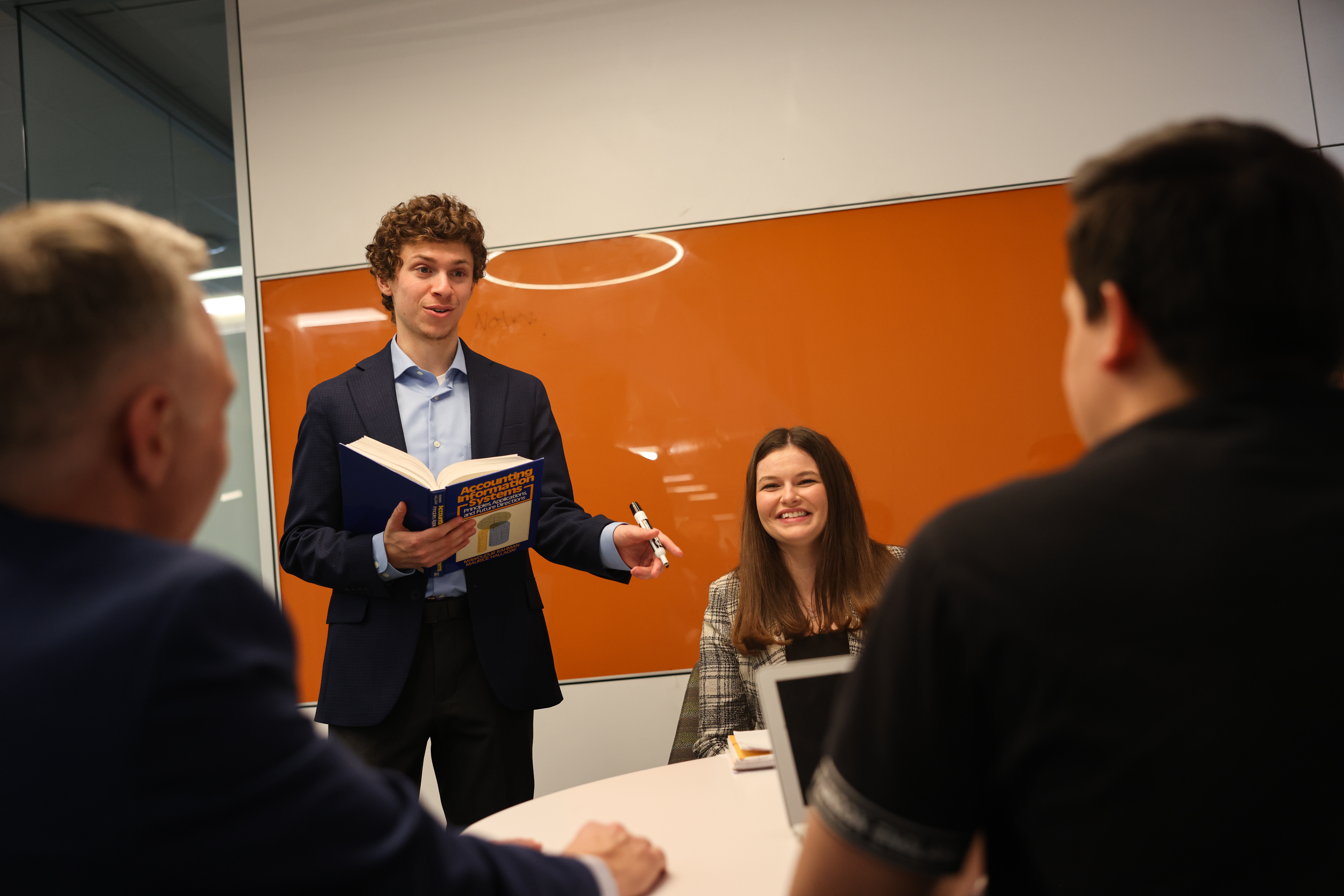 A student in business attire gives a presentation.