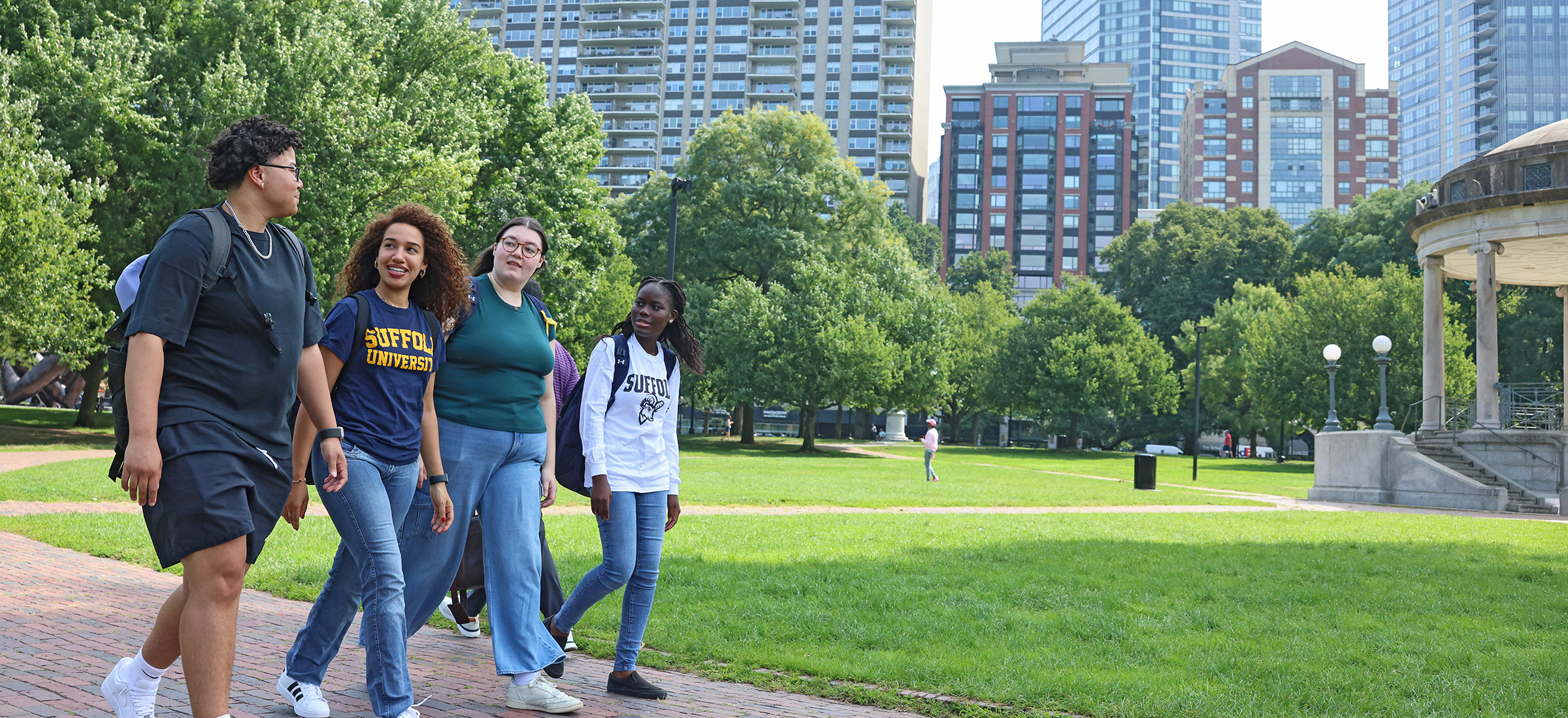 A group of Suffolk students walking together along a path on the Boston Common.