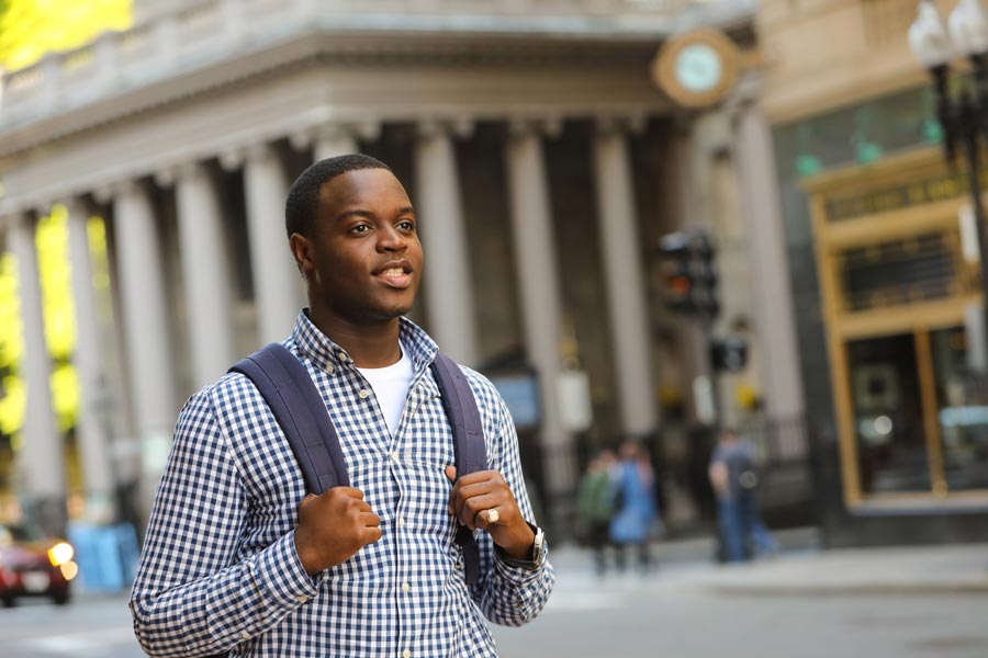 Suffolk student Markendy glances forward down Tremont Street in front of Suffolk's building.