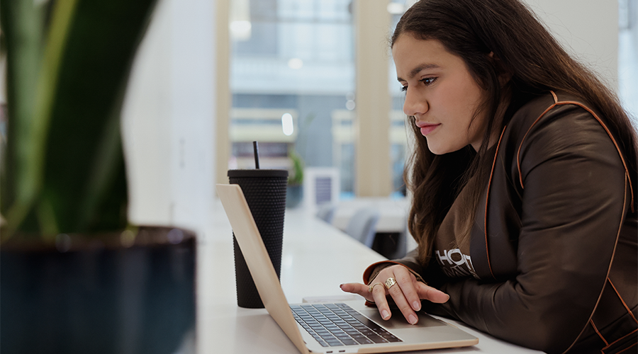 A Suffolk Student works on her laptop in the career center.