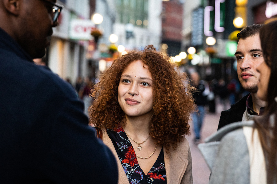 A group of Suffolk students talking in Downtown Crossing.